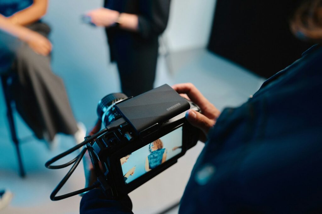 A person holding a camera in front of a group of people